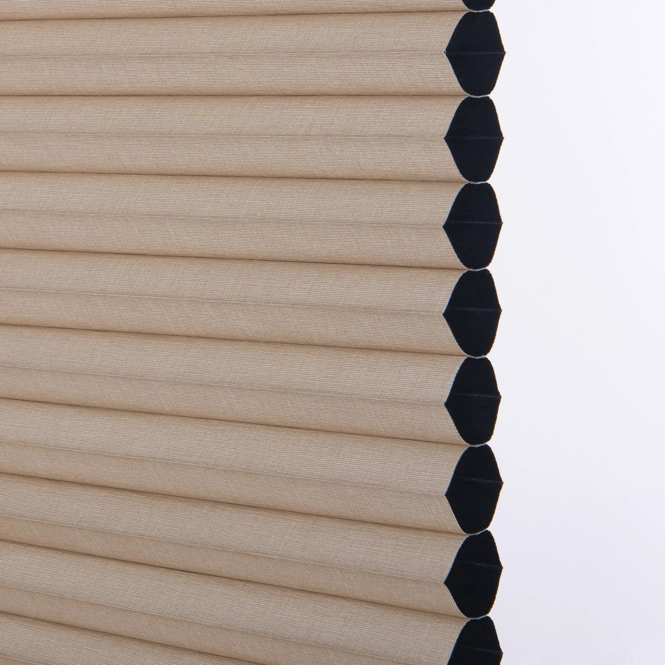 Close-up of a CAIC honeycomb fabric in linen sand, showing the pleated cell edge